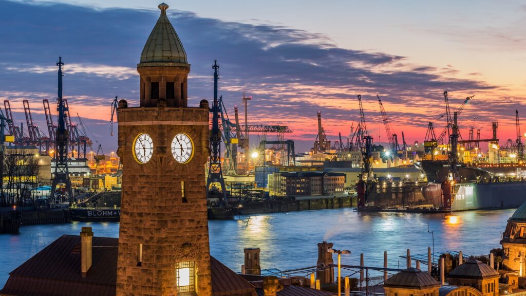 Hamburg – Hafen bei Sonnenuntergang mit beleuchteten Kränen und Containerschiffen, Hamburg, Deutschland